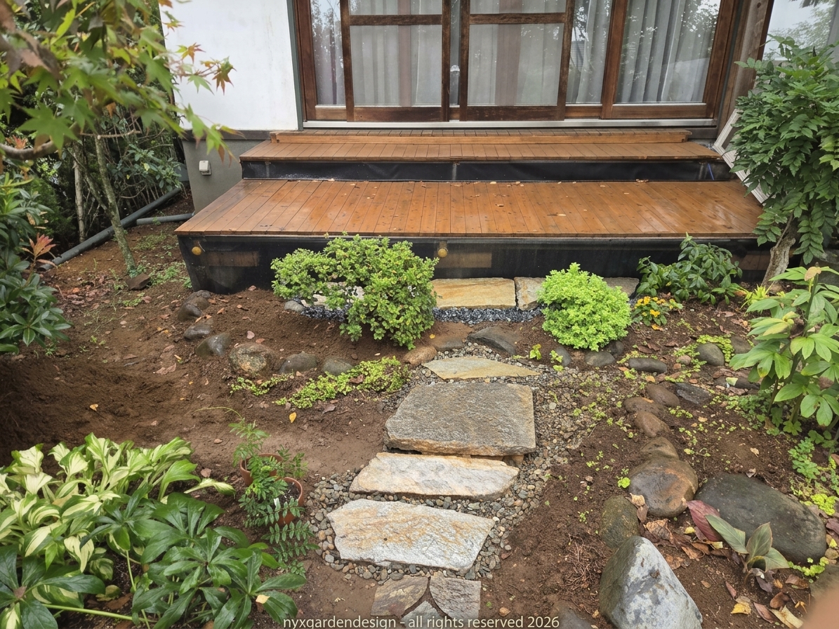 A Japanese garden stepping-stone path leading to a timber deck, surrounded by carefully layered planting